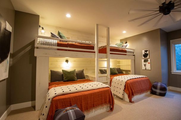 Childrens bunk room with built in lighting and white wood