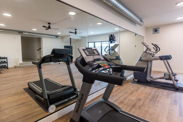 Workout room with treadmills and large wall mirrors