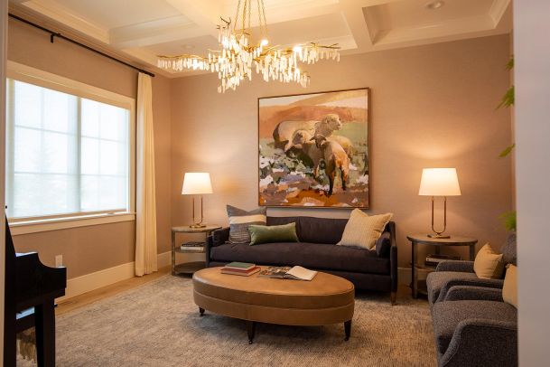 Elegant living room with crystal branch chandelier and dark sofa