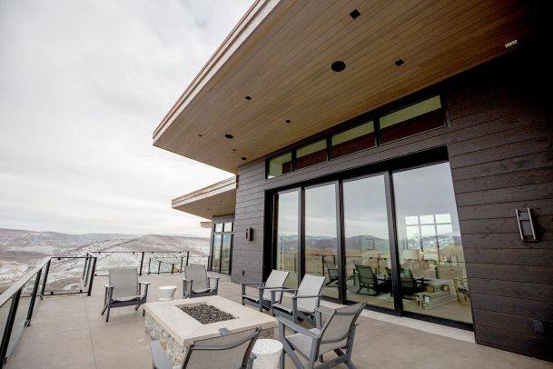 Large outdoor deck with fire pit and glass railings