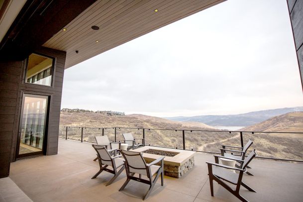 Wide outdoor terrace with stone fire pit and valley overlook