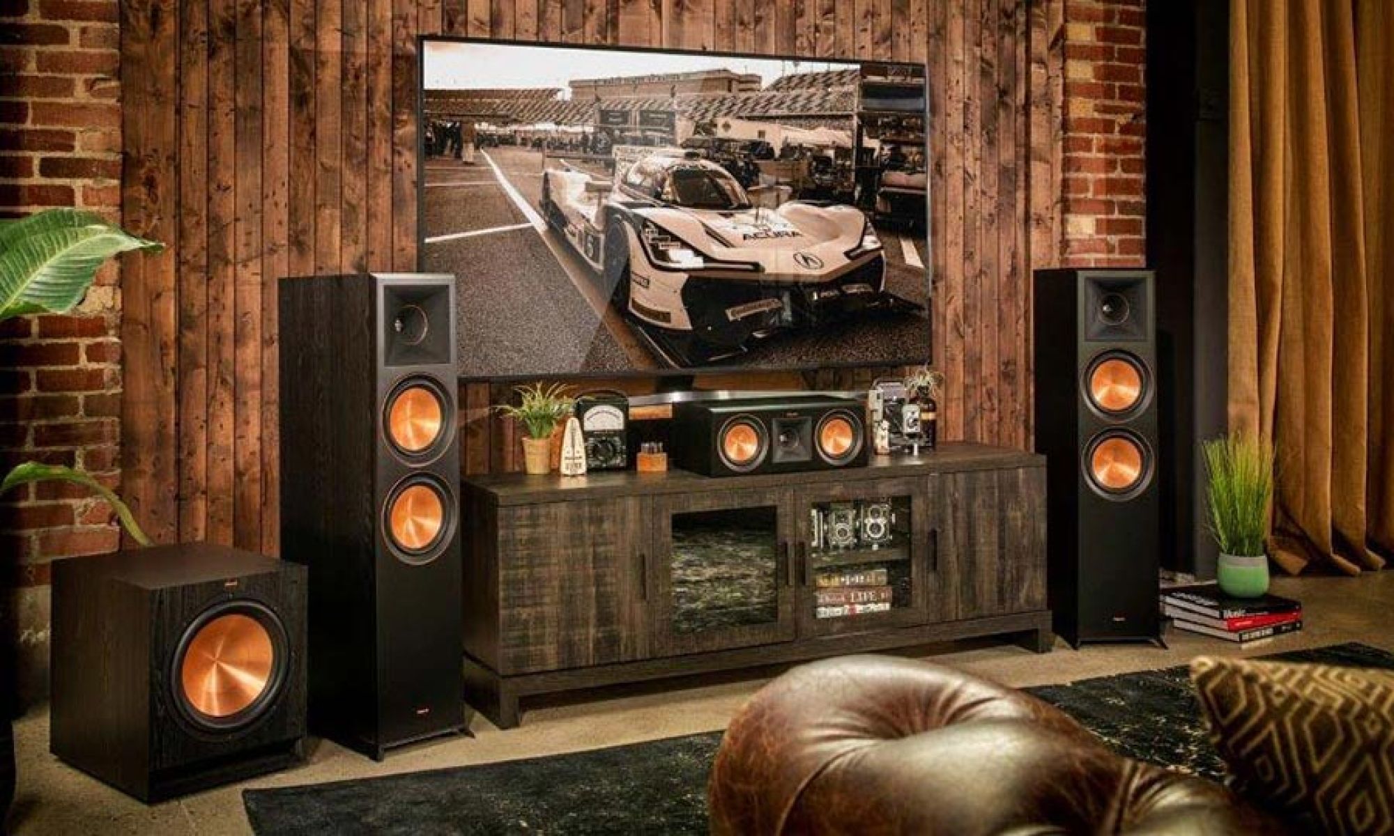 Home theater setup with tower speakers, subwoofer, and media console