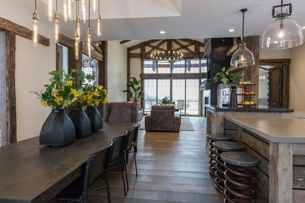 Open concept dining and living room with rustic beams