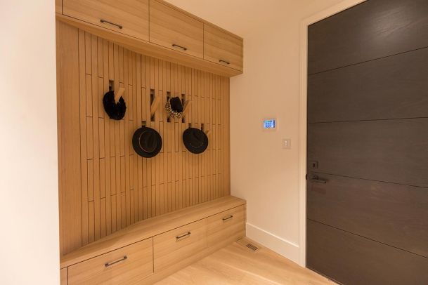 Mudroom with wood slat walls and smart control panel