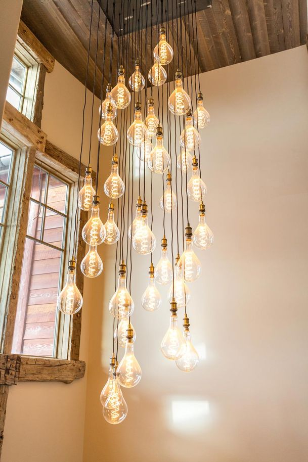Large cluster of hanging Edison bulbs in a stairwell