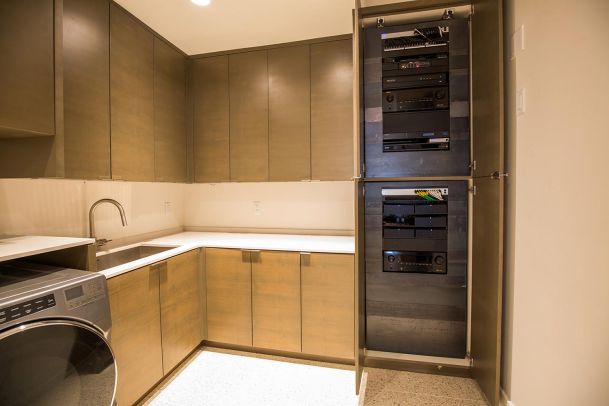 Professional AV equipment rack inside a laundry room cabinet