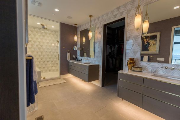 Large master bathroom with geometric tile and dual mirrors