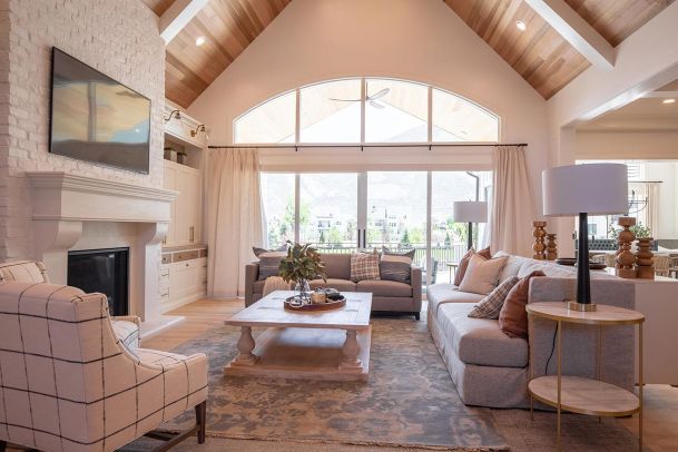 Bright great room with large arched window and mountain view