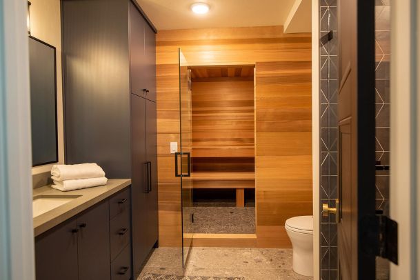 Modern bathroom with cedar wood sauna and glass door