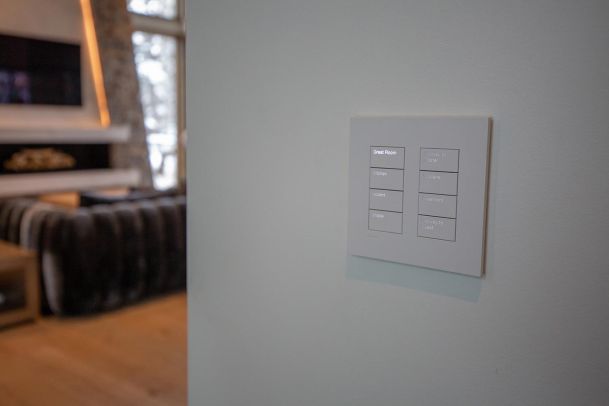 Close up of engraved smart lighting keypad on a white wall