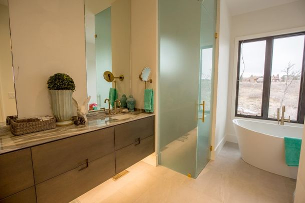 Clean bathroom with freestanding tub and frosted glass