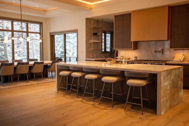 Modern kitchen and dining area with snowy outdoor view