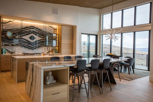 Modern kitchen with marble island and large windows