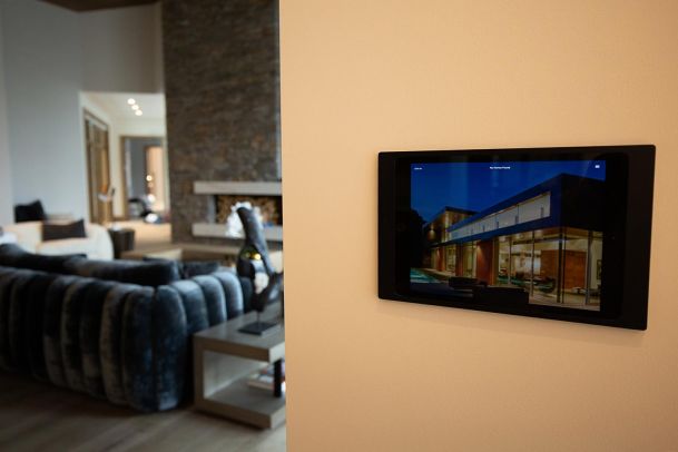 Wall mounted tablet displaying smart home control interface
