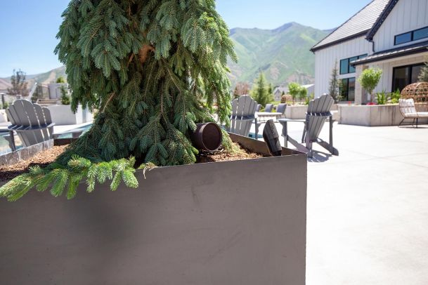 Discreet outdoor landscape speaker tucked in a planter