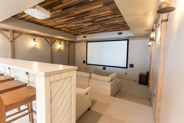 Rustic home theater with reclaimed wood ceiling and screen